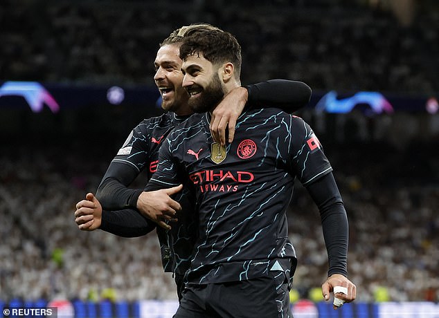 The unlikely scorer celebrates with Jack Grealish after netting the game's fifth goal